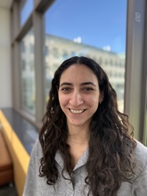 Photo of Alex Bova standing in front of a window